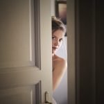 photo of woman behind door