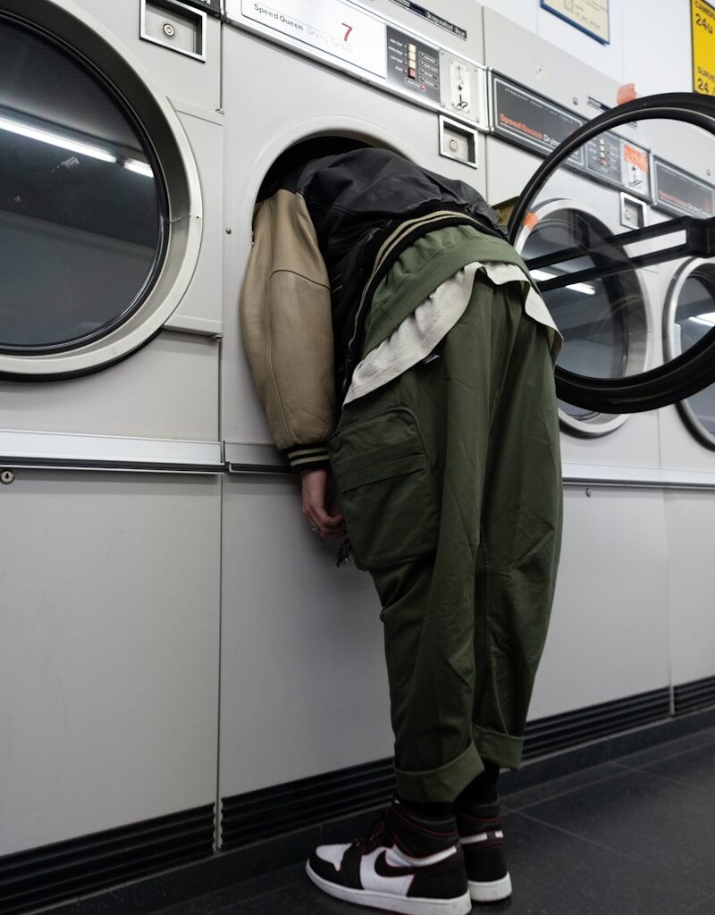 green jacket on white front load washing machine