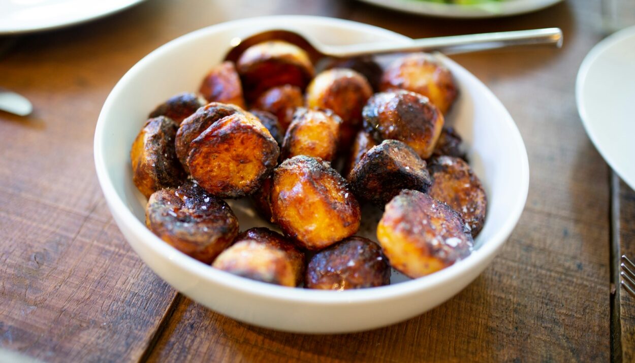 selective focus photography of glazed nuts inside white ceramic saucer